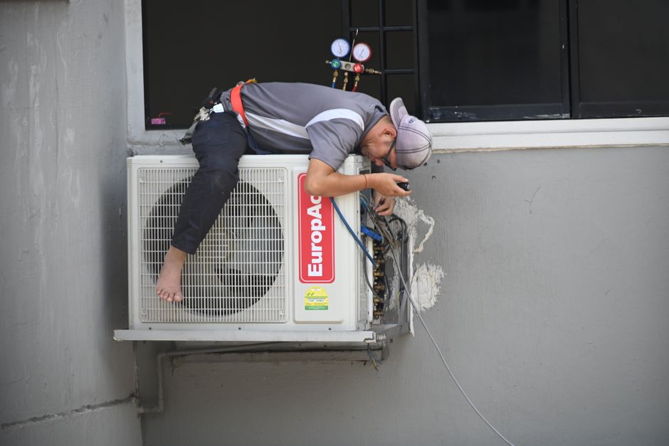 HVAC technician servicing an air conditioning system